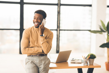 Happy black businessman talking on the phone