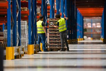 Warehouse workers make a list of goods
