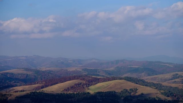 Time lapse of blue sky with clouds over mountain hills. Autumn sunny day landscape nature video