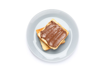 Toasts with chocolate cream on plate isolated on white background