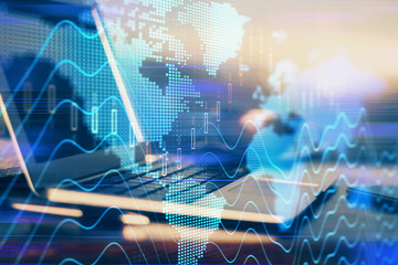 Financial graph colorful drawing and table with computer on background. Double exposure. Concept of international markets.