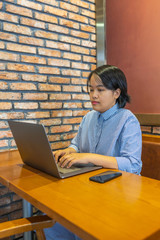 Portrait of female copywriter focus on working and typing laptop