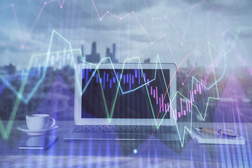 Forex graph hologram on table with computer background. Multi exposure. Concept of financial markets.
