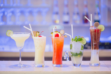 Margarita cocktai,cocktail different refreshing gin and tonics in  4 glasses. Cherryand ,melon, pomegranate and pineapple, lemon.