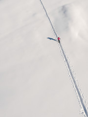 Trekking on the snow, man walking in mountain
