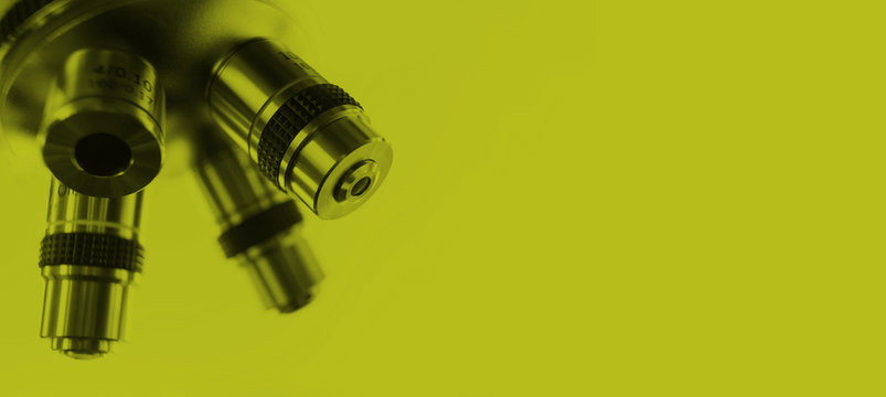 Optical microscope - science and laboratory equipment. Microscope is used for conducting planned, research experiments, educational demonstrations in medical and clinical laboratories. Light green ton