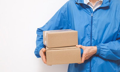 Man courier holds delivery boxes on a white background.