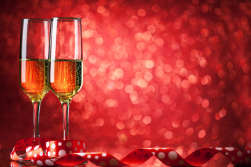 Champagne glasses on a beautiful bokeh background. Valentine's day. Background with copy space. Selective focus. Horizontal.
