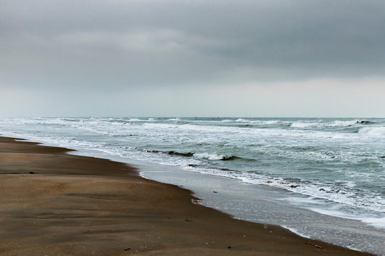 Koksijde, Belgium - November 15, 2019: A wild North Sea on a dark cloudy day