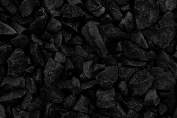 Natural fire ashes with dark grey black coals texture. It is a flammable black hard rock. Space for...