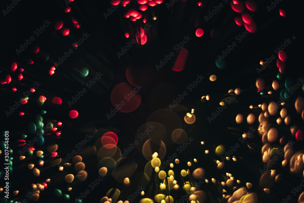 Poster beautiful magic gold and red bokeh background in the darkness.