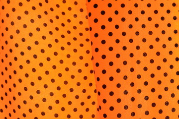 Black round dot on bright yellow fabric background. A weave of cloth texture surface detail with natural light. Women dress, fashion wallpaper or backdrop with copy space for text