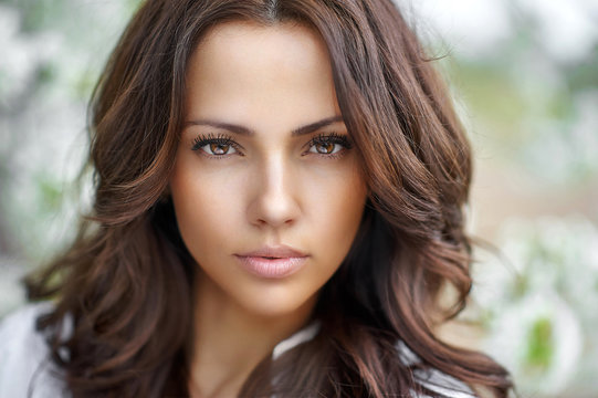 Beautiful brunette woman face close up - perfect skin