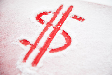Dollar sign in the snow. Red dollar sign on a snowy car hood. The concept of an accident in bad weather, a large repair cost