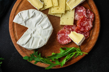 camembert or brie, cheese plate (different types of cheese, grocery, sausage) menu concept. food background. top view. copy space