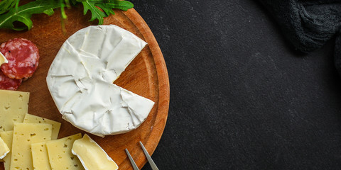 camembert or brie, cheese plate (different types of cheese, grocery, sausage) menu concept. food background. top view. copy space