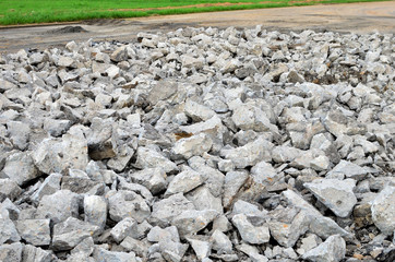 Hardcore waste recycling. Broken concrete slabs at construction site. oncrete rubble from demolition at landfill.  Recycling and reuse crushed concrete rubble, asphalt, building material, blocks.