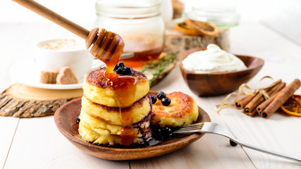 Cottage cheese pancakes with honey. Breakfast or Lunch Concept.