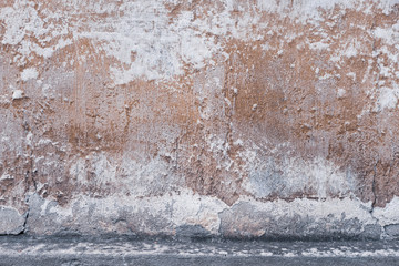 Abstract grunge texture of old colorful wall with cracks and scratches. Creative background. Gray, white, brown and orange rough weathered stone texture with stucco and paint. Copy space