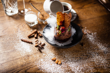 Chocolate mousse served with liquid ice smoke