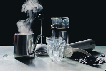 Aromatic coffees in French press coffee maker with couple glass and Antique coffee bean grinder using hand crank,Hot drink is good for health,Wood table,Black background,Natural light,Healthy Eating.