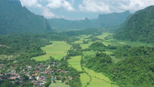 Aerial view of village Vang Vieng and Nam Song rive , Laos. Southeast Asia. Photo made by drone from above. Bird eye view..