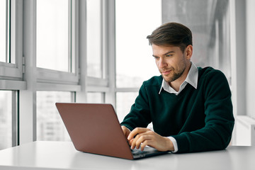 young man working on laptop at home