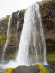 A prominent area in front of the impressive Seljalandsfoss waterfall. With the wide cavern behind the water curtain. South Coast of Iceland.