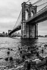 View of Brooklyn Bridge from below in black and white