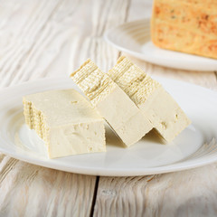 Soy Bean curd tofu on clay dish closeup. Non-dairy alternative substitute for cheese