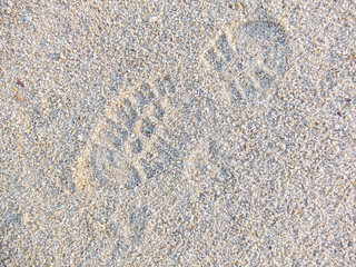 Top view of footprint on sand 