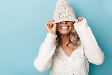 Portrait of nice cheerful woman laughing and making fun with her hat