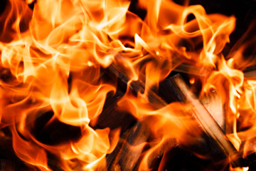 Texture of a flame of fire on a black background. burning fire in a stove closeup