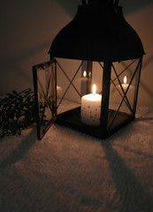 Fototapeta na wymiar Black lantern and snowflake candle