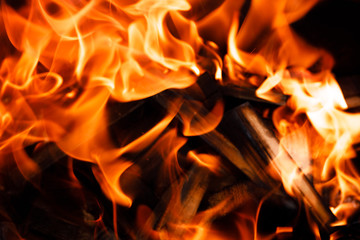Texture of a flame of fire on a black background. burning fire in a stove closeup