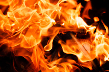 Texture of a flame of fire on a black background. burning fire in a stove closeup
