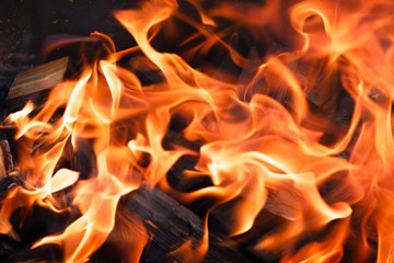 Texture of a flame of fire on a black background. burning fire in a stove closeup
