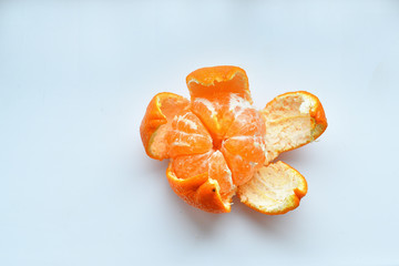 peeled tangerine on a white background.Orange fruits and peeled segment Isolated. Pile of orange segments