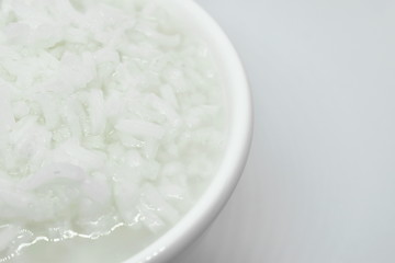 Fototapeta na wymiar boiled rice in cup on white background