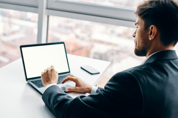 businessman working on laptop in park