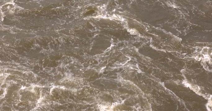 draining water thrashes and swirls from a lock