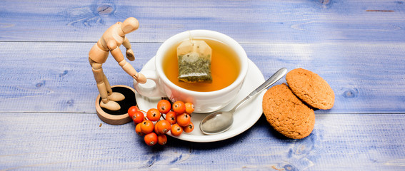 Cup of tea on blue background close up. Gourmet delicious taste. Cafe menu. Berry tea. Ceramic cup hot fresh brewed tea beverage. Drink aromatic rowanberry beverage. Health care folk remedies