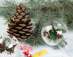 decorative background, blue spruce branch with balls and cone, colored lollipops