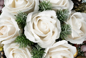 Close-up of Christmas bouquet with flowers and spruce with snow.