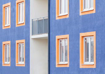 Wall of a new low-rise building close-up. The wall of the house is blue.