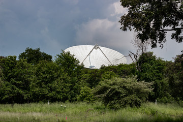 Big Satellite dish or radio antennas against in forest