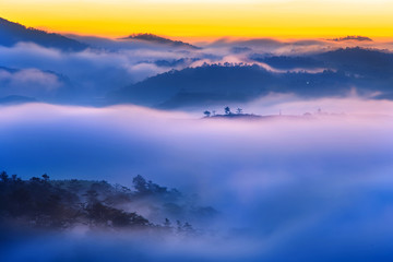 Dreamy scenery of mountains in misty sunset evening