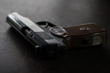 closeup pistol on a black table