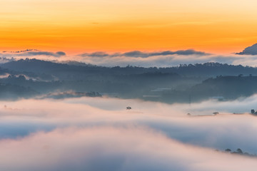 Beautiful foggy and cloudy mountain range landscape at sunrise morning