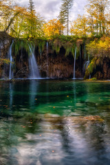 Plitvice lakes (Plitvicka jezera) national park, Croatia. Amazing autumn sunny landscape with waterfall Mali Buk, Gradinsko lake, colored trees and sky. Outdoor travel background, famous landmark